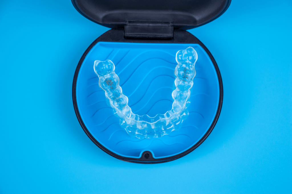 a clear dental aligners in a blue container